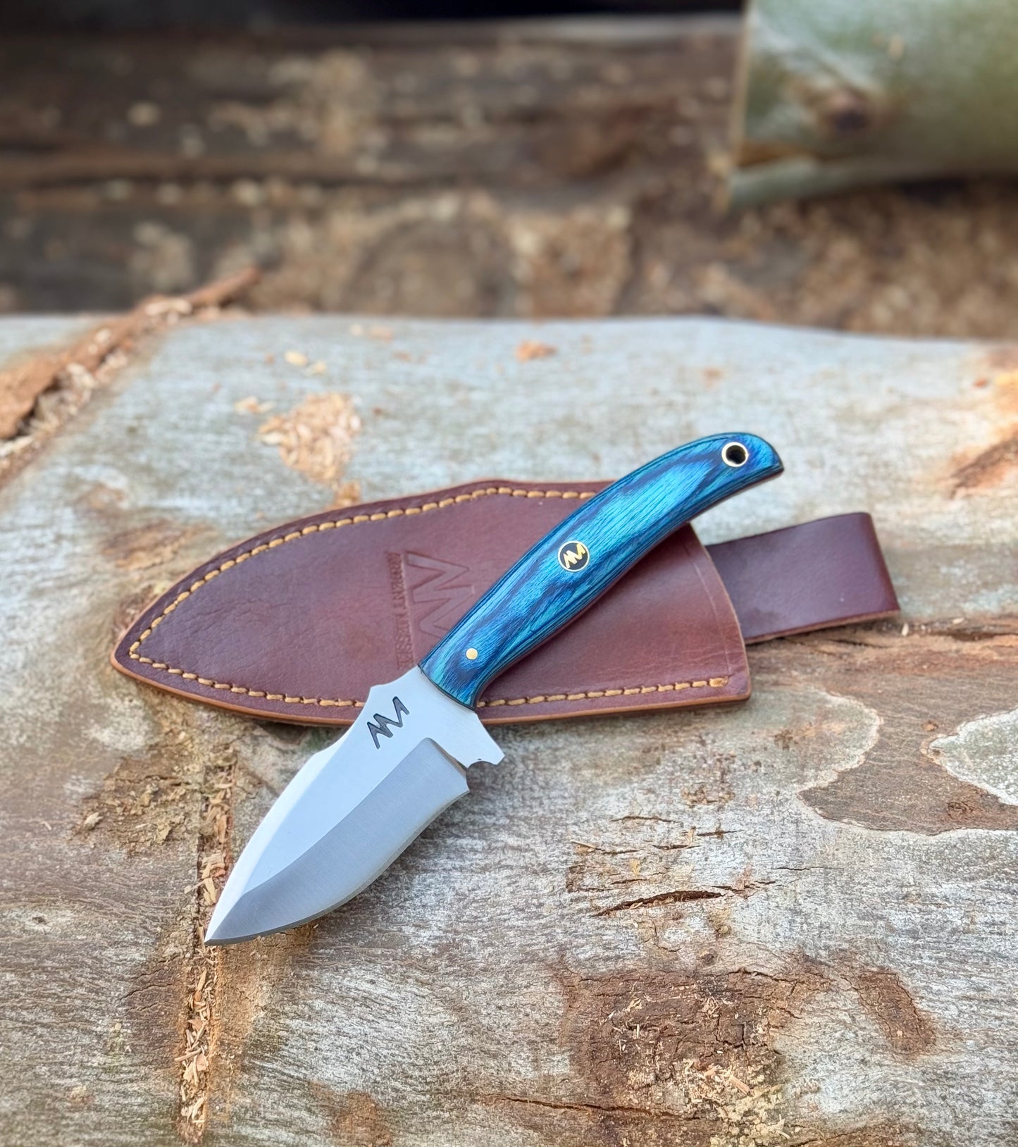 7.5" Fixed Blade Knife with 12c27 Steel and Striking Blue handle with a lanyard hole and branded mosaic pins, and a premium leather sheath