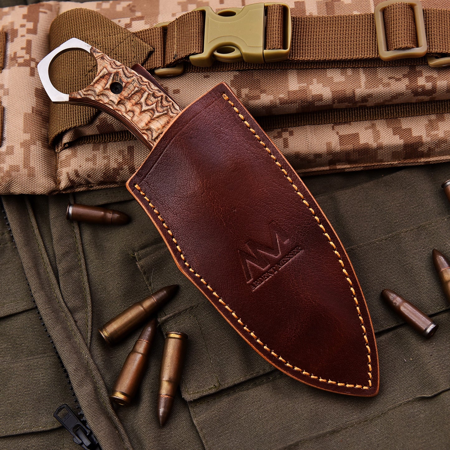 AM Onyx fixed blade tactical knife placed in its hand stitched leather sheath