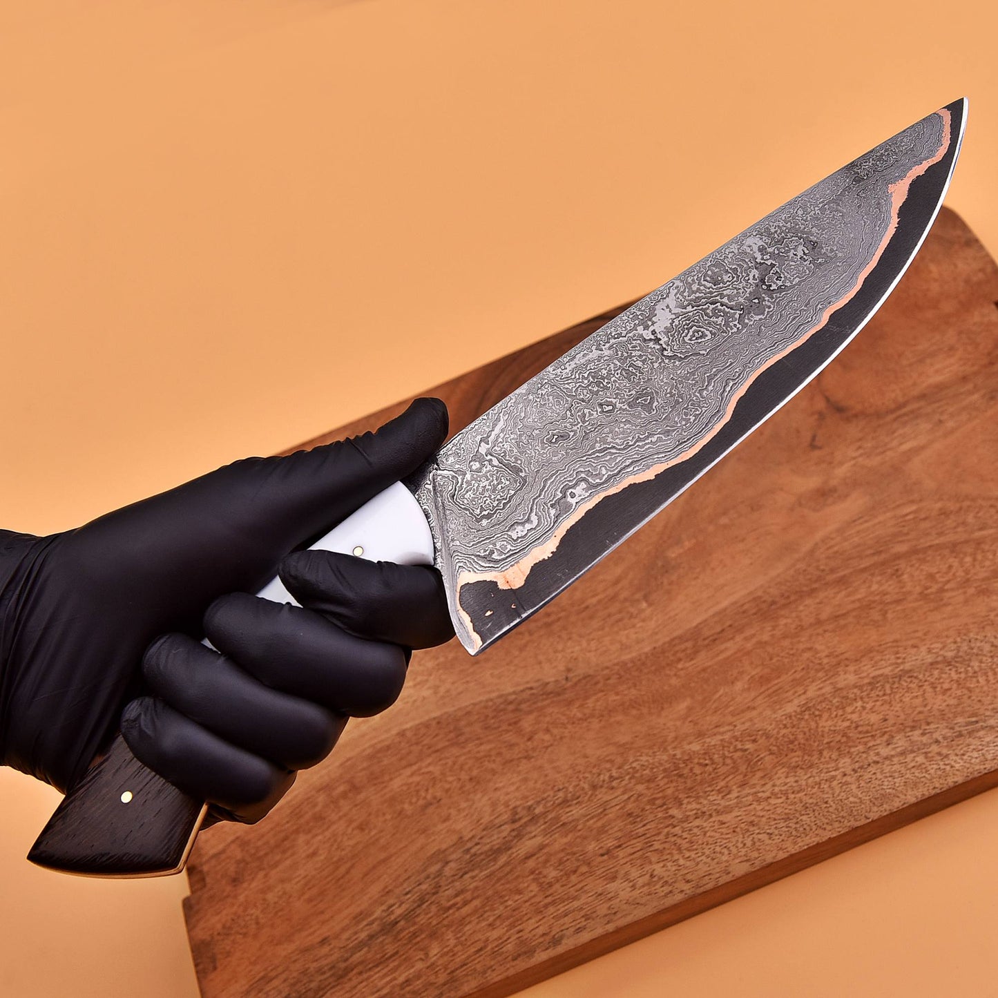 Close-up of copper Damascus steel pattern on chef knife