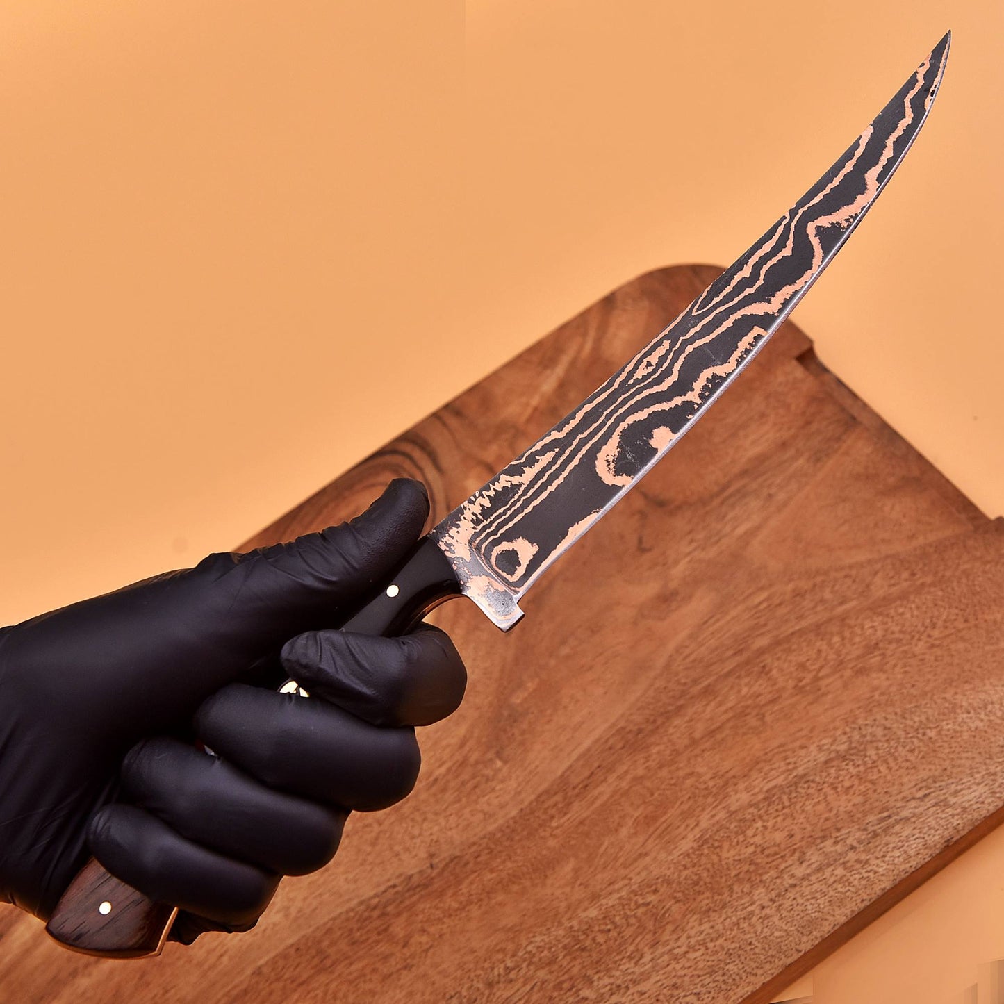 AM Inferno knife held in hand to show balance, ergonomics, and precision fit