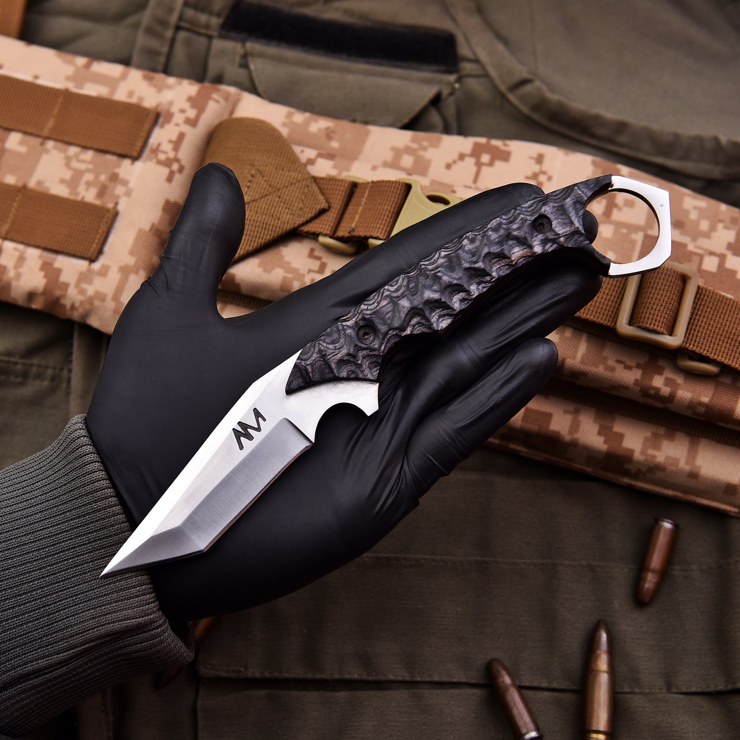 AM Sentinel knife in hand showing ergonomic grip and tactical finger ring design