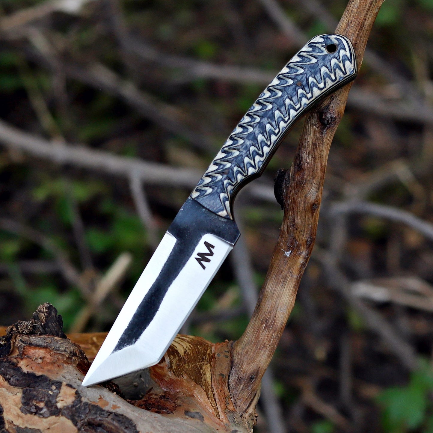 AM Shadowstrike knife resting on weathered wood background, showing full tang design and copper-toned wood handle texture.