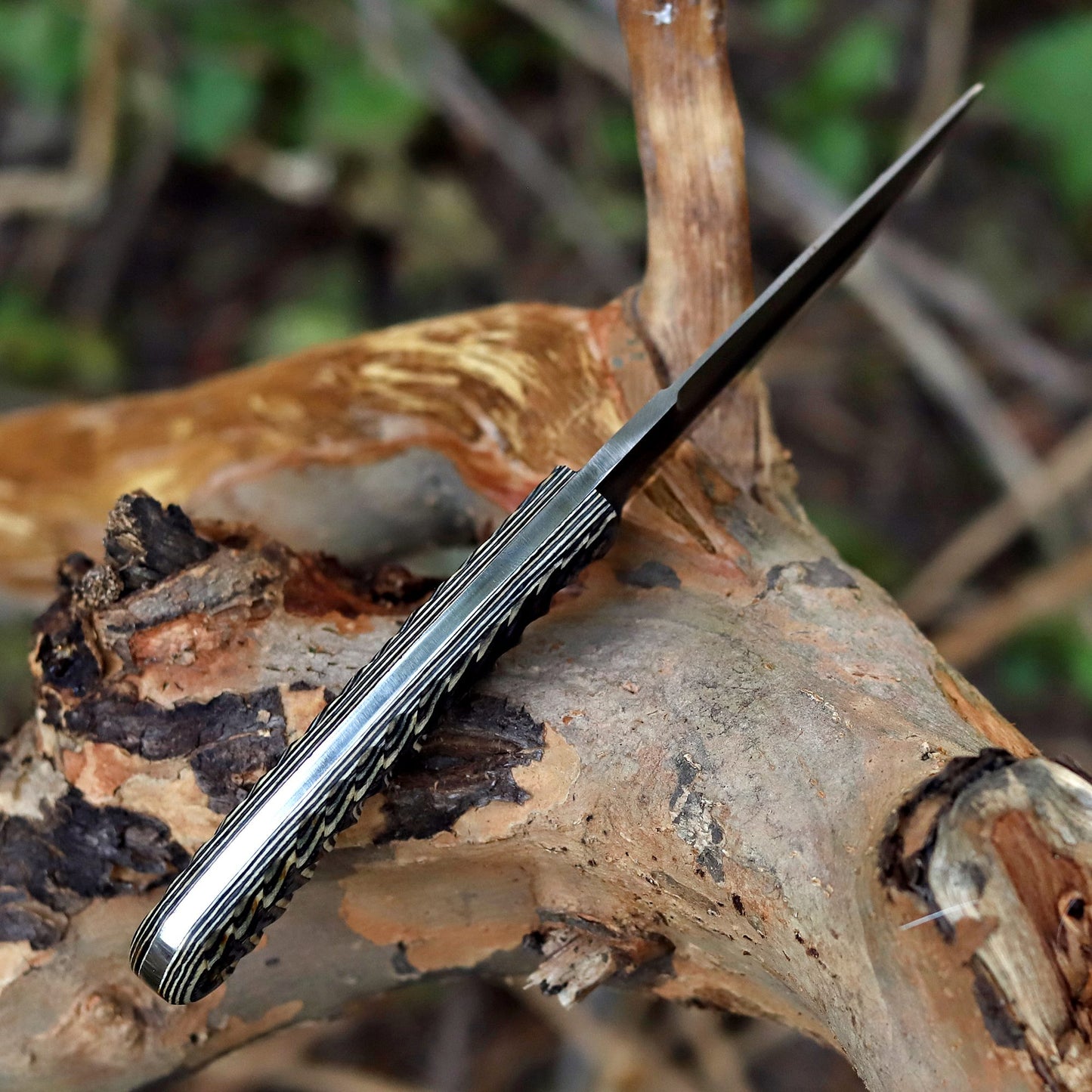 Top view of AM Shadowstrike 12C27 steel tanto blade emphasizing spine thickness and precision grind geometry.