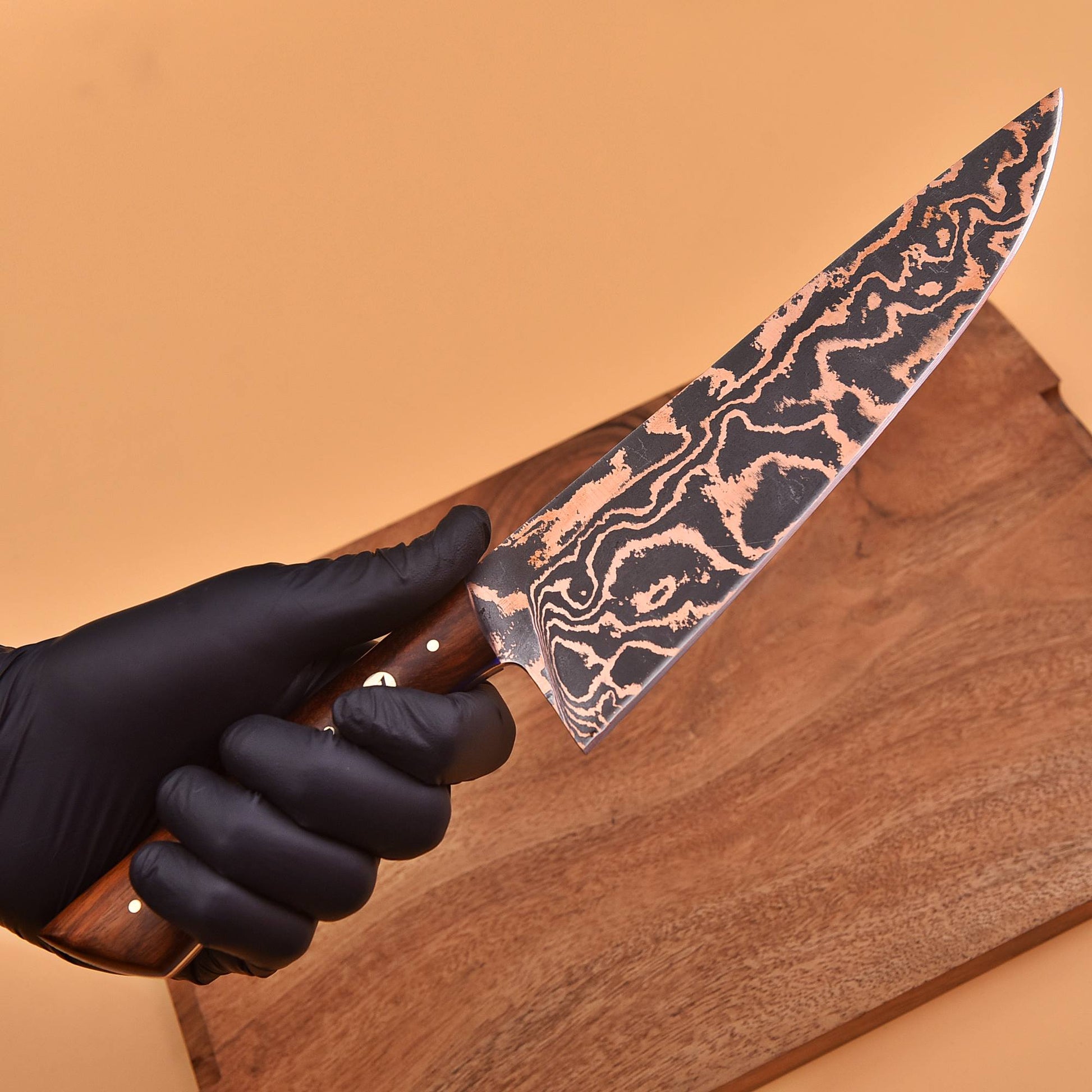 Close-up of copper Damascus blade on Santoku knife
