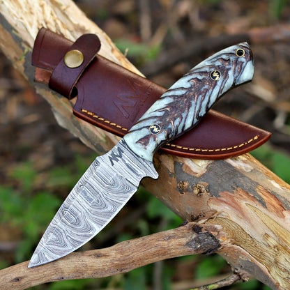 AM Shard fixed blade knife displayed beside its custom leather sheath — handcrafted precision and rugged elegance.